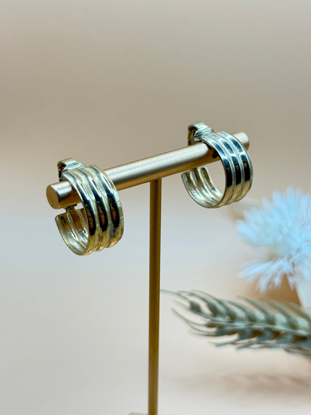 Classic vintage Monet gold tone hoop earrings with comfortable clip-on backs and a polished finish.